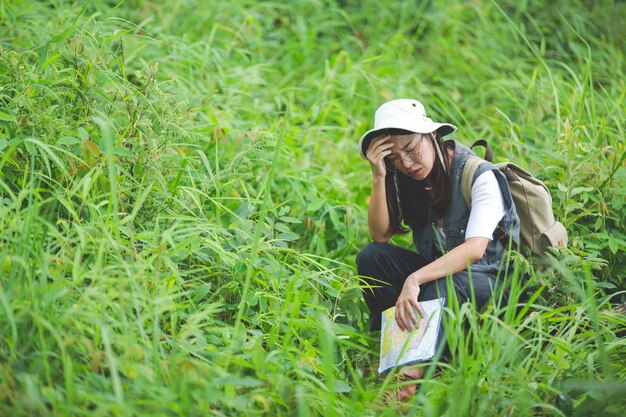 A happy hiker walks through the jungle with a backpack.