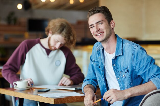 Happy hipster at the cafe