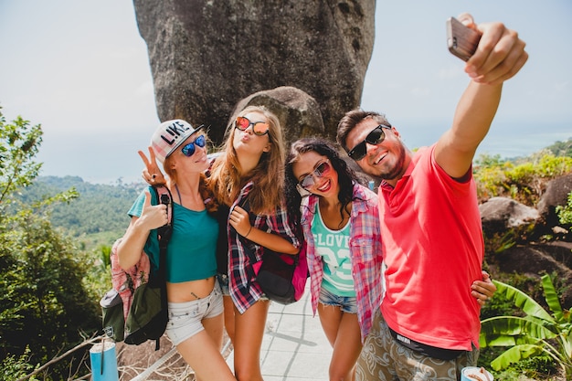 Happy hipster company of friends traveling around world