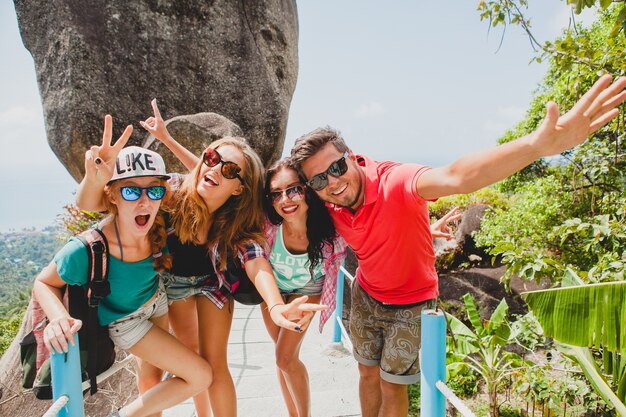 Happy hipster company of friends traveling around world