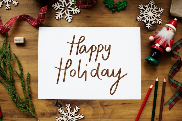 Free Photo happy holiday card on a wooden table