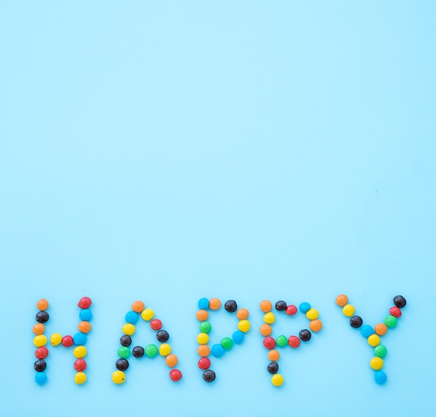 Happy inscription from candies on table