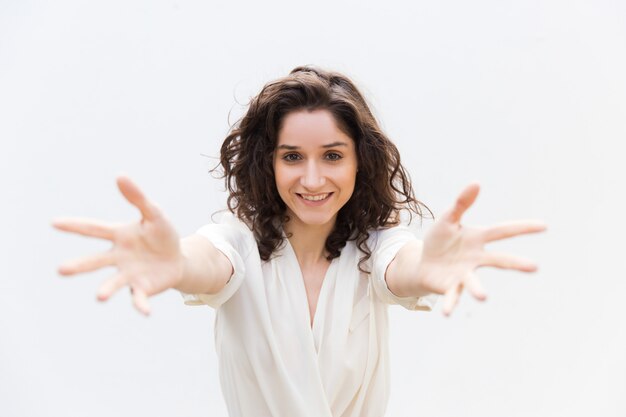 Happy joyful beautiful woman outstretching hands