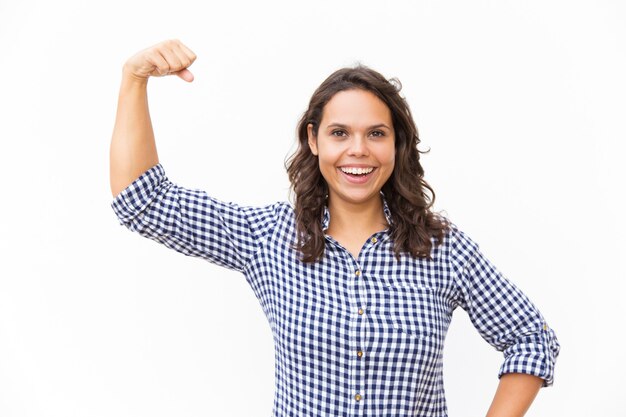 Happy joyful feminist flexing and showing bicep