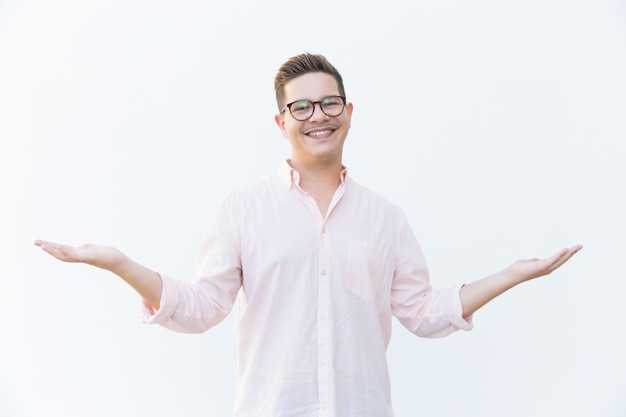 Happy joyful guy in eyeglasses presenting copy space