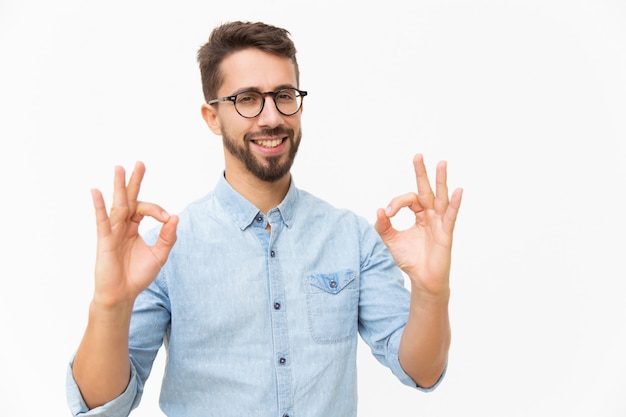 Happy joyful guy showing OK gesture