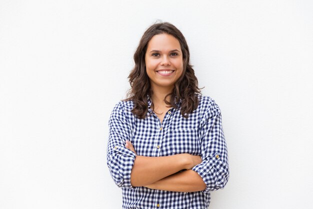 Happy joyful woman with arms folded looking