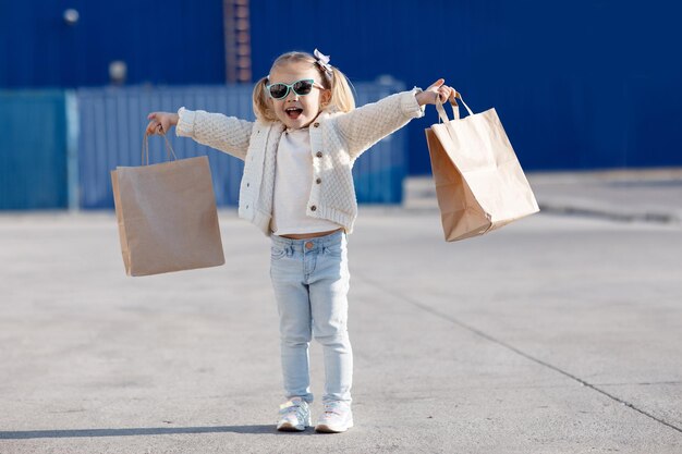 happy kid is shopping outdoors