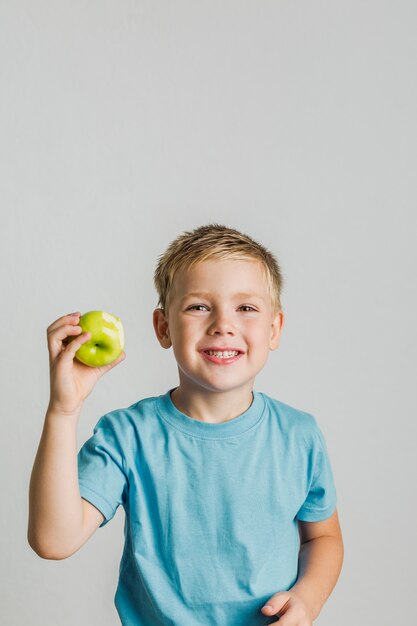 Happy kid with a green apple