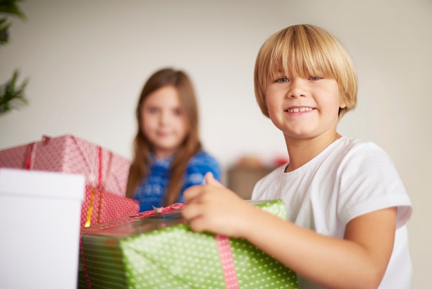 Happy kids holding Christmas presents