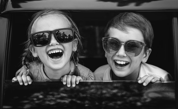 Free photo happy kids looking out the car window