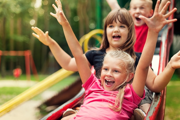 Happy kids playing on slide