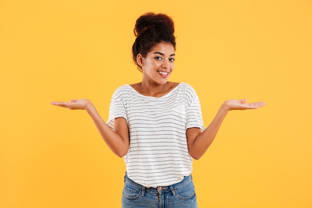 Happy lady holding on her hand copy space and smiling