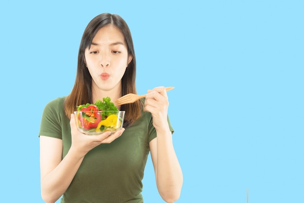 Happy lady holding kitchen stuff over copy space background 