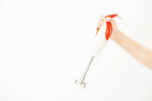 Happy lady holding kitchen stuff over copy space background 