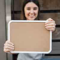 Free photo happy lady with wood tablet