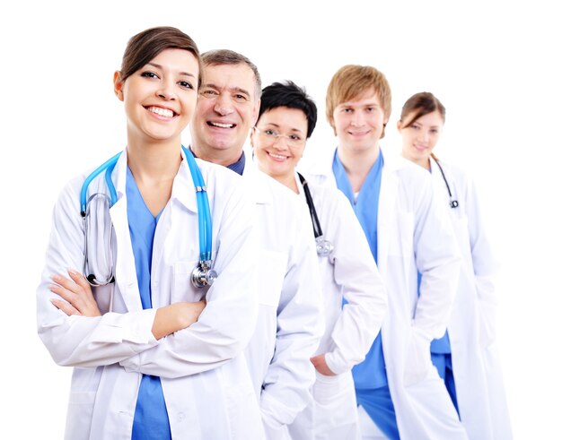 Happy laughing female doctors in hospital gowns in row