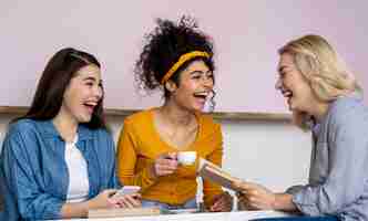 Free photo happy laughing women having coffee