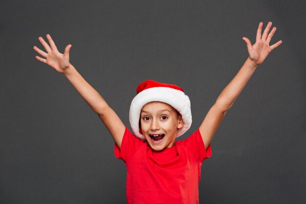 Happy little boy child wearing christmas santa hat