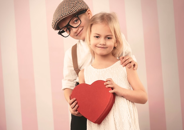 Free photo happy little couple with valentine's gift