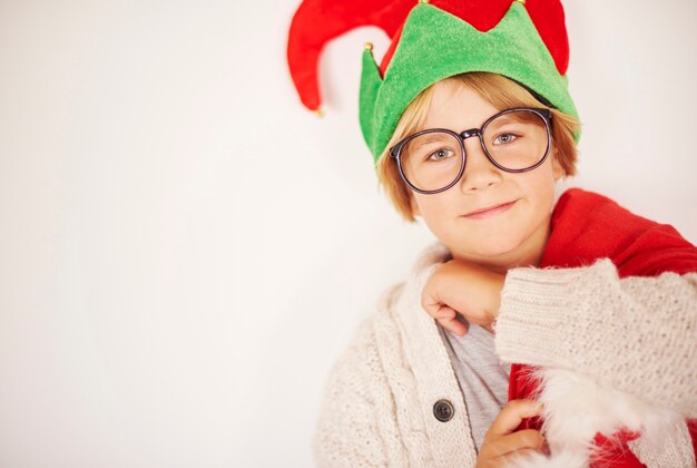 Happy little elf with sack od Christmas presents