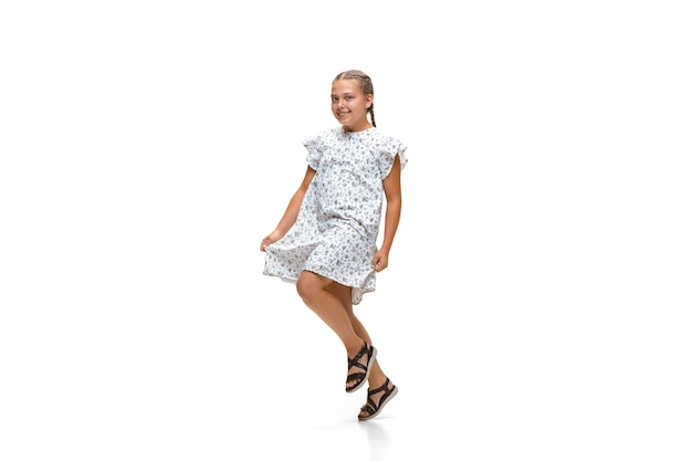 Happy little girl running isolated on white