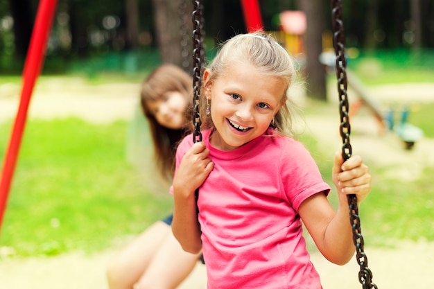 Happy little girl on swing