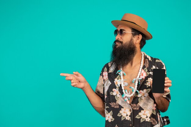 The  of a happy long beard man wearing a hat, wearing a striped shirt, holding a phone on a blue .