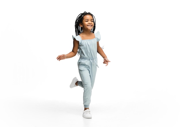 Happy longhair brunette little girl isolated on white studio background Looks happy cheerful sincere Copyspace Childhood education emotions concept