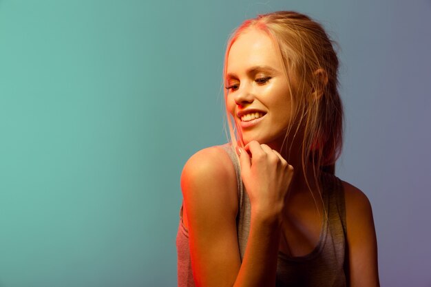 Happy lovely young woman standing and posing