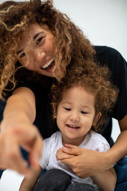 Happy loving family mother and her daughter child girl playing and hugging