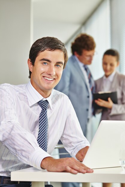 Happy male executive with a white shirt