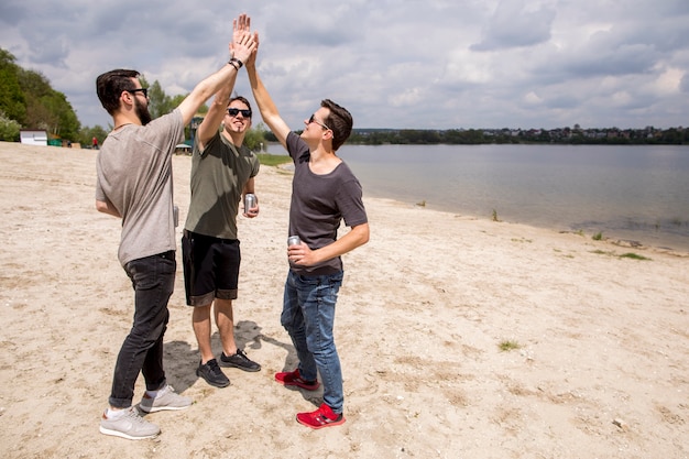 Happy male friends giving high five