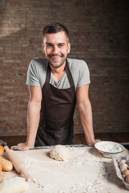 Happy male maker in bakery