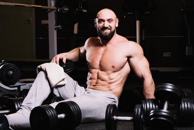 Happy man amidst dumbbells