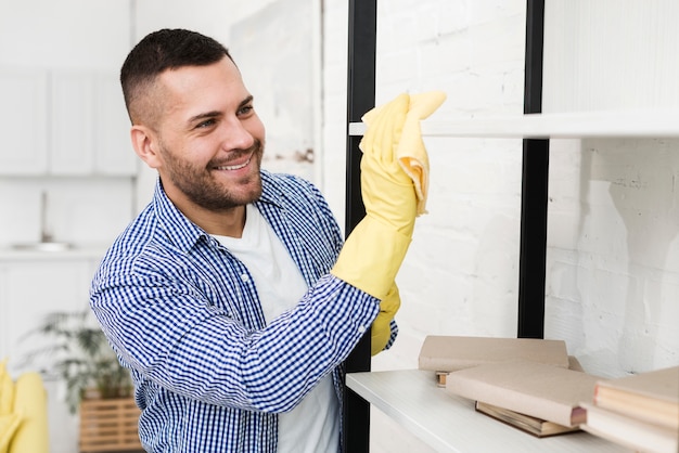 Free photo happy man cleaning with rag