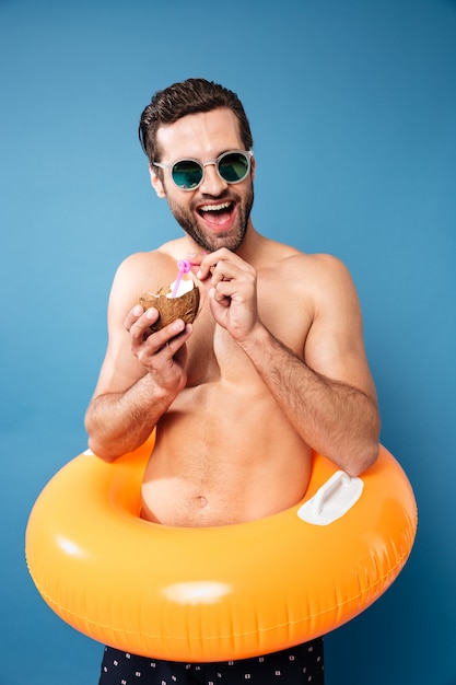 Happy man drinking coconut cocktail