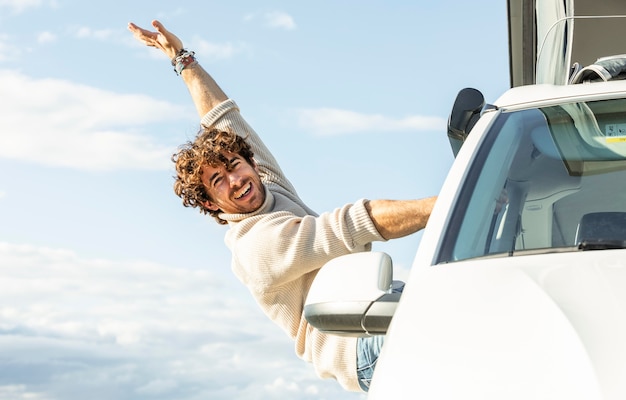 Happy man enjoying a road trip