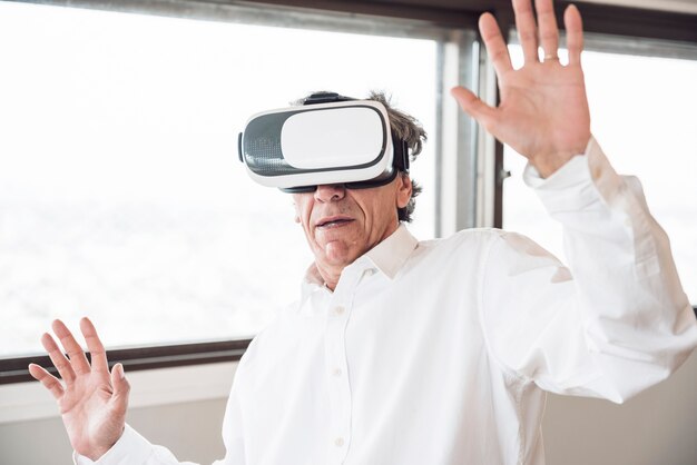 Happy man exploring virtual reality headset simulation