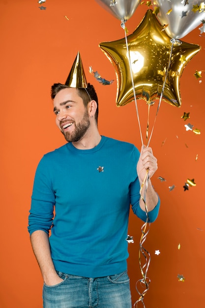 Happy man holding balloons