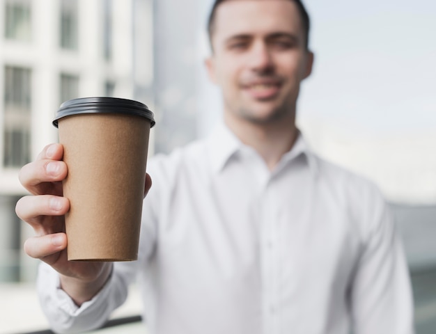 Happy man holding coffee cup
