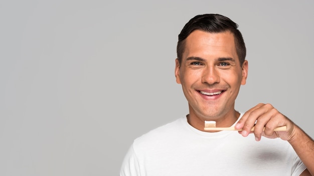 Happy man holding toothbrush