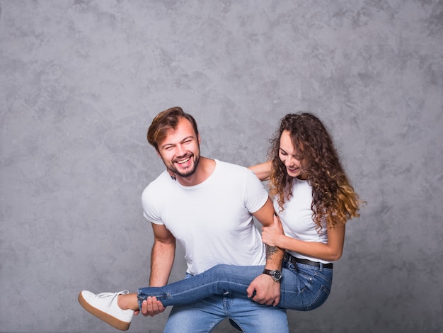 Happy man holding woman leg 