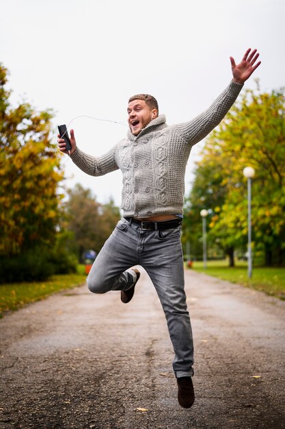 Happy man jumping up in the park