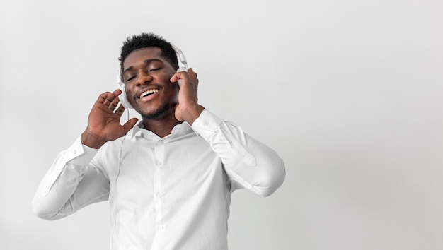 Free photo happy man listening to music