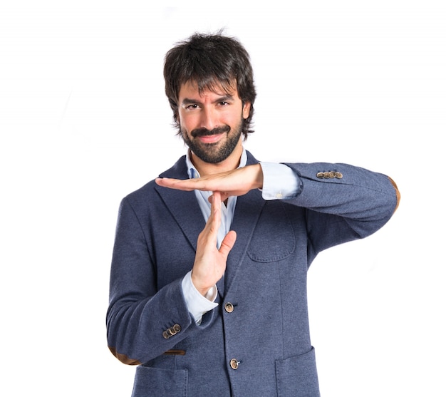 Happy man making time out gesture over white background