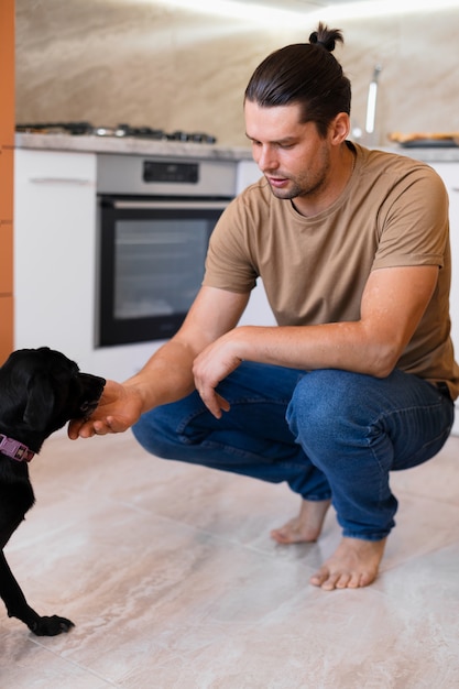 Free photo happy man moving in his new home with his dog