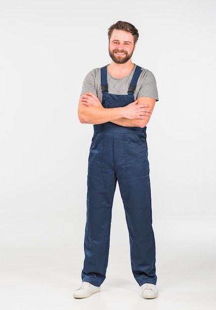 Happy man in overall with crossed arms 