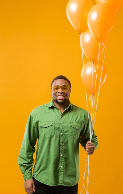 Happy man at party holding balloons