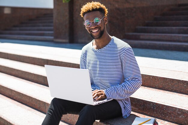 Happy man posing with laptop